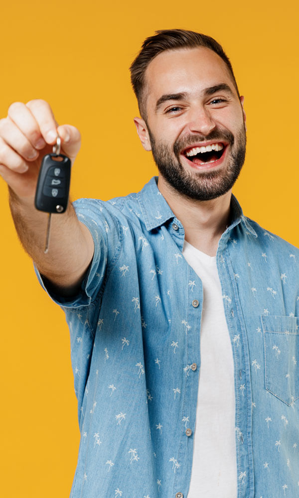 man smiling giving key